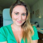 Picture of a smiling white woman with blonde hair and green eyes