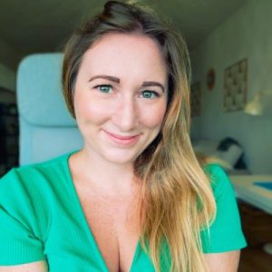 Picture of a smiling white woman with blonde hair and green eyes